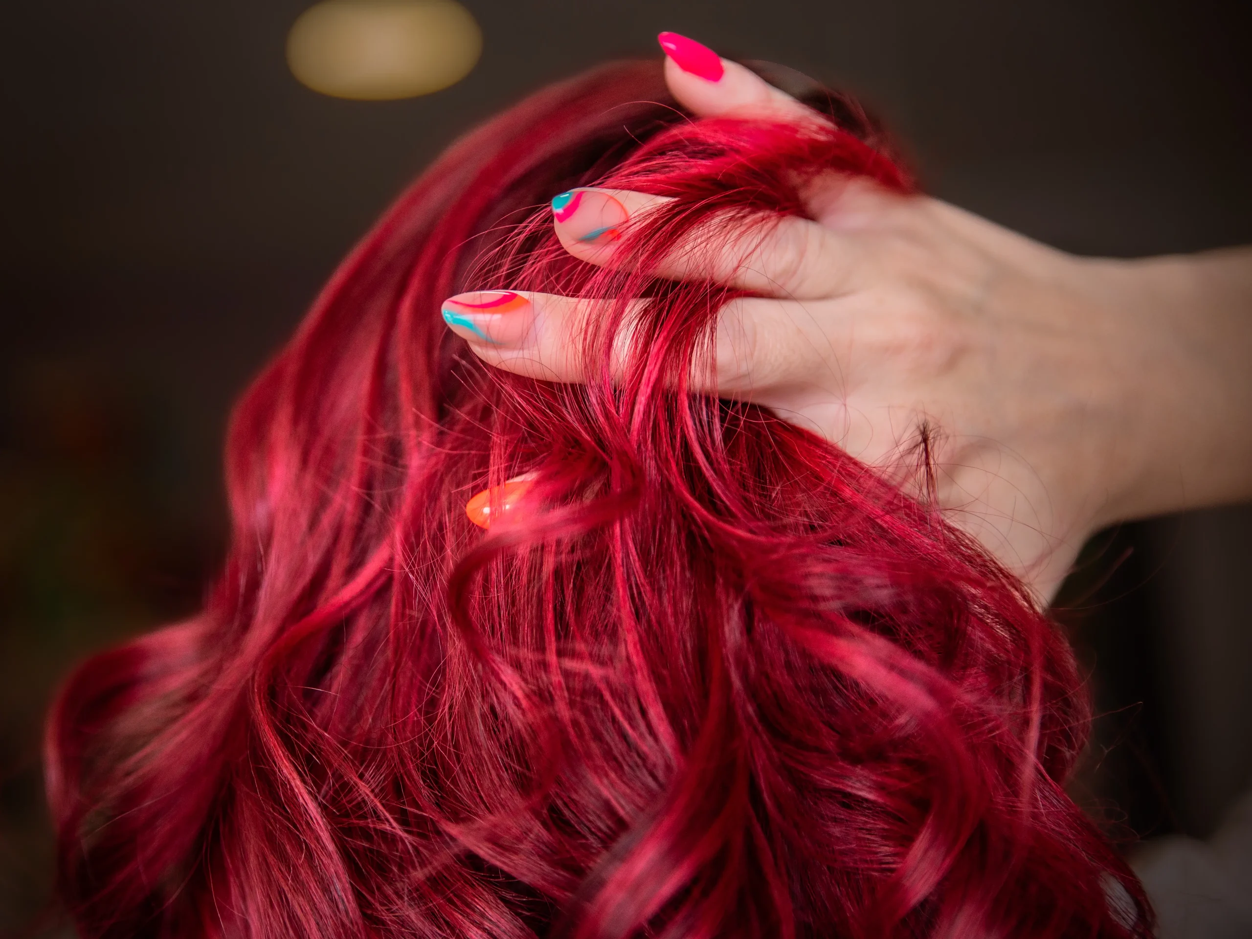 femme-passe-main-dans-ses-cheveux-manucure